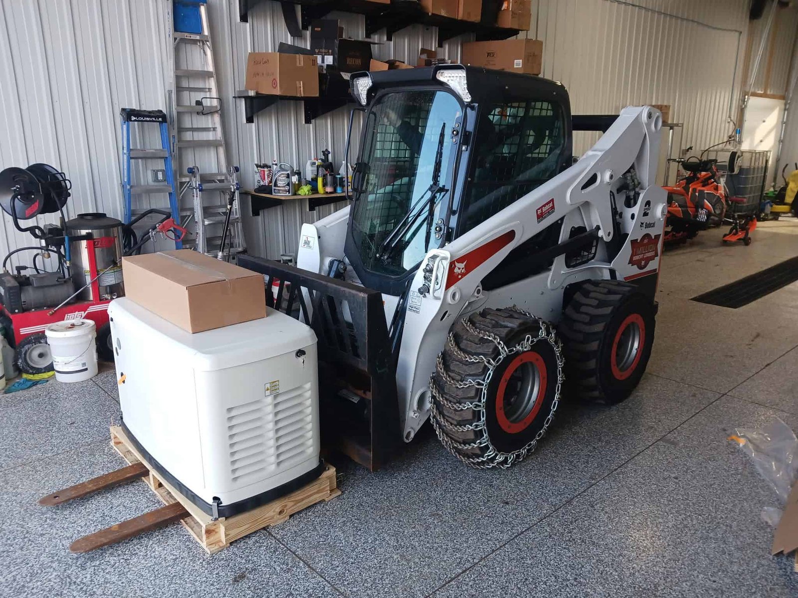 Generac generator sitting on bobcat forks in warehouse