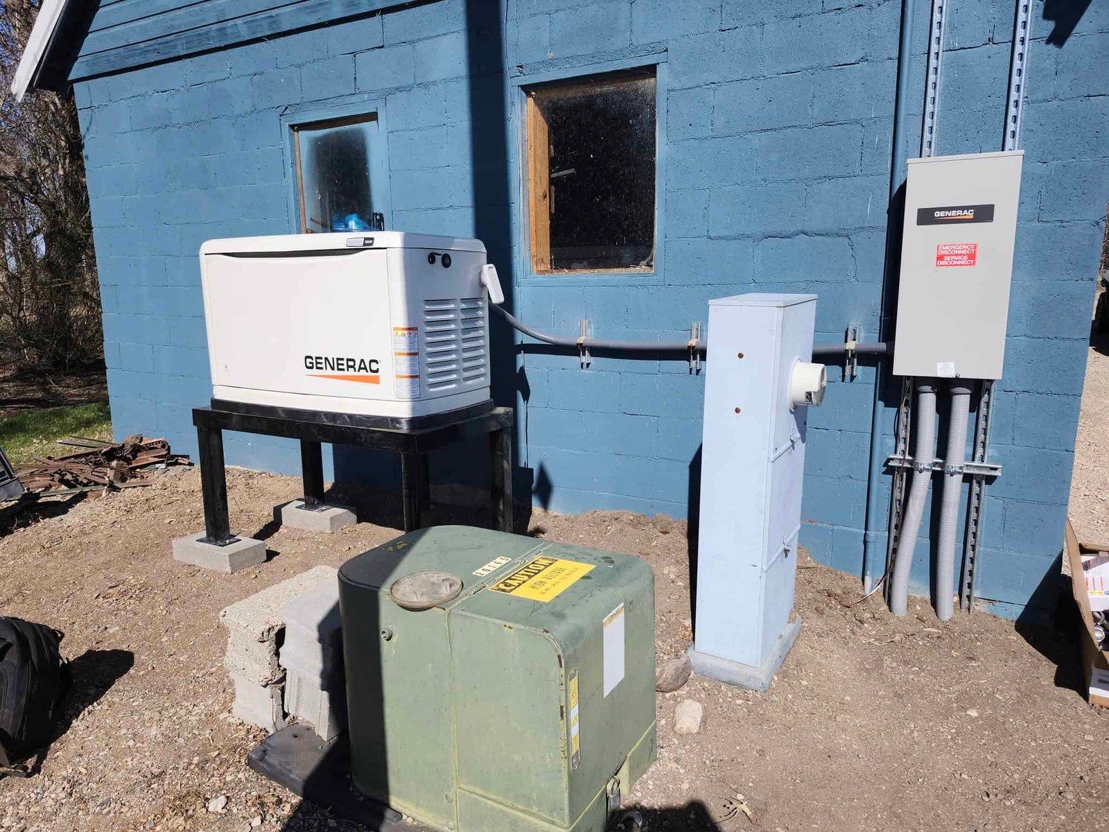 Generator on stand next to blue building